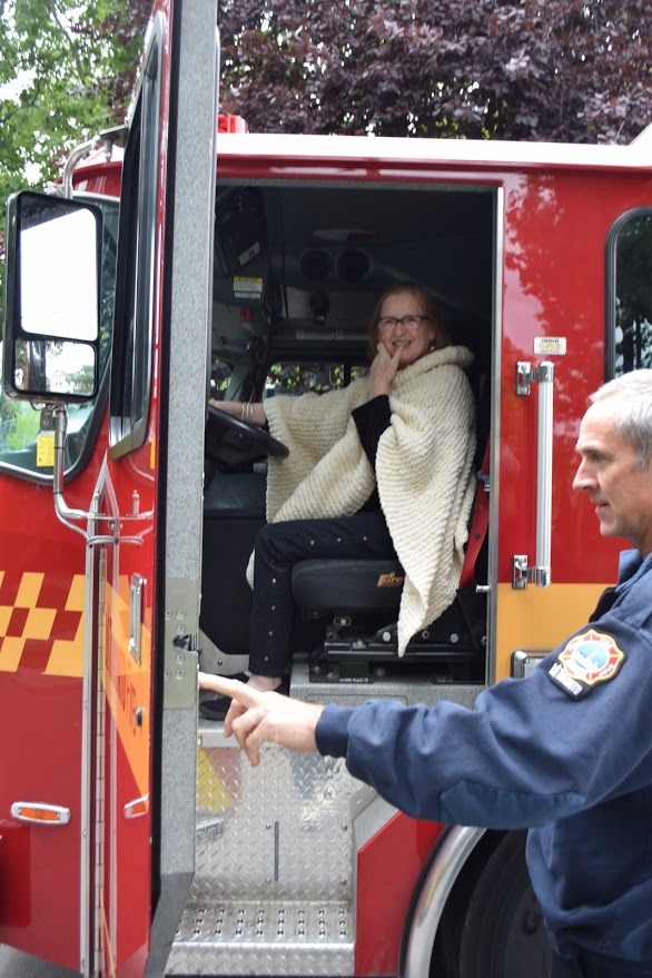 woman pretending to drive a firetruck