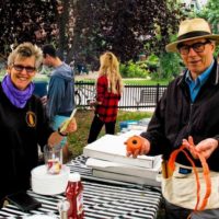 two smiling people, selling tickets at Fall Fair