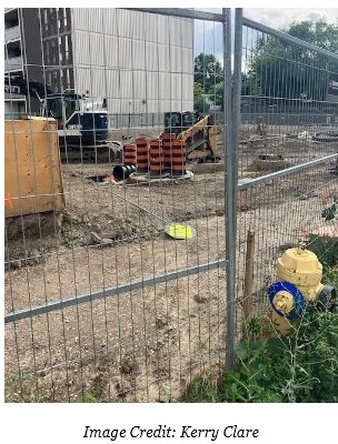 Messy construction site next to tall building at 666 Spadina Ave.
